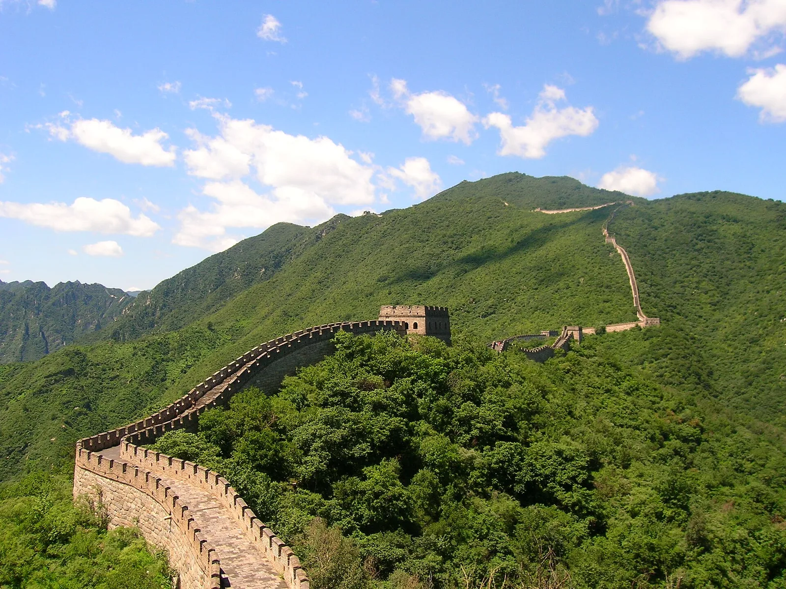 The Great Wall crossing green mountain ridges near Beijing.