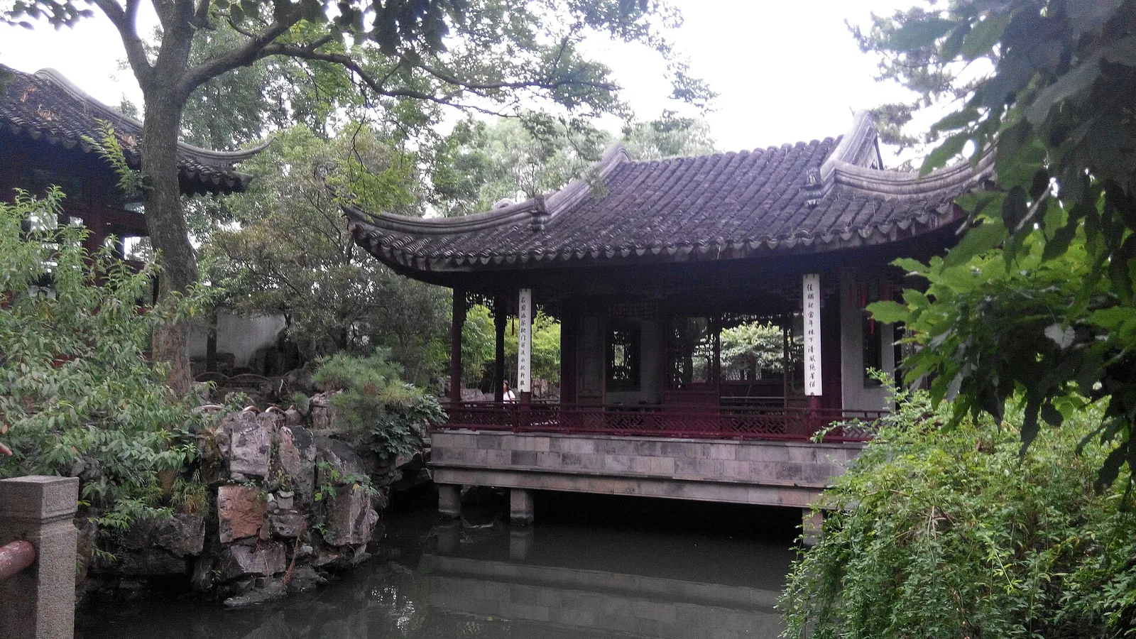 A pavilion beside water in a classical Suzhou garden.